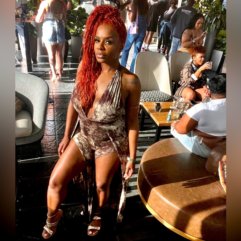 Brown and mint Jumpsuit has splits on front of legs . Jumpsuit is very stretchy